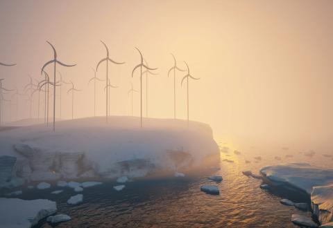 A group of windmills on a snowy hill next to a body of water 